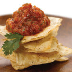 Charred Tomato n Onion Salsa on stack of tortilla chips