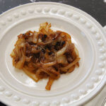 White plate with caramelized onions in middle